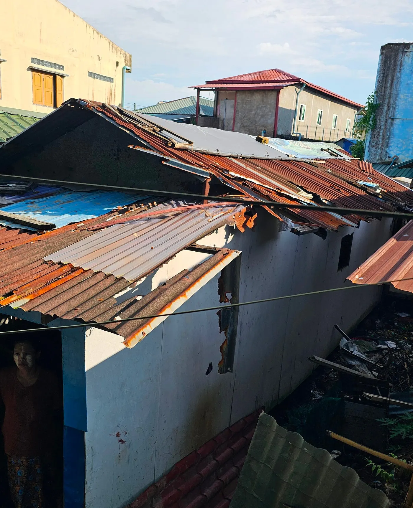 Crowded, patched rooftops in Hlaing Thar Yar before repair